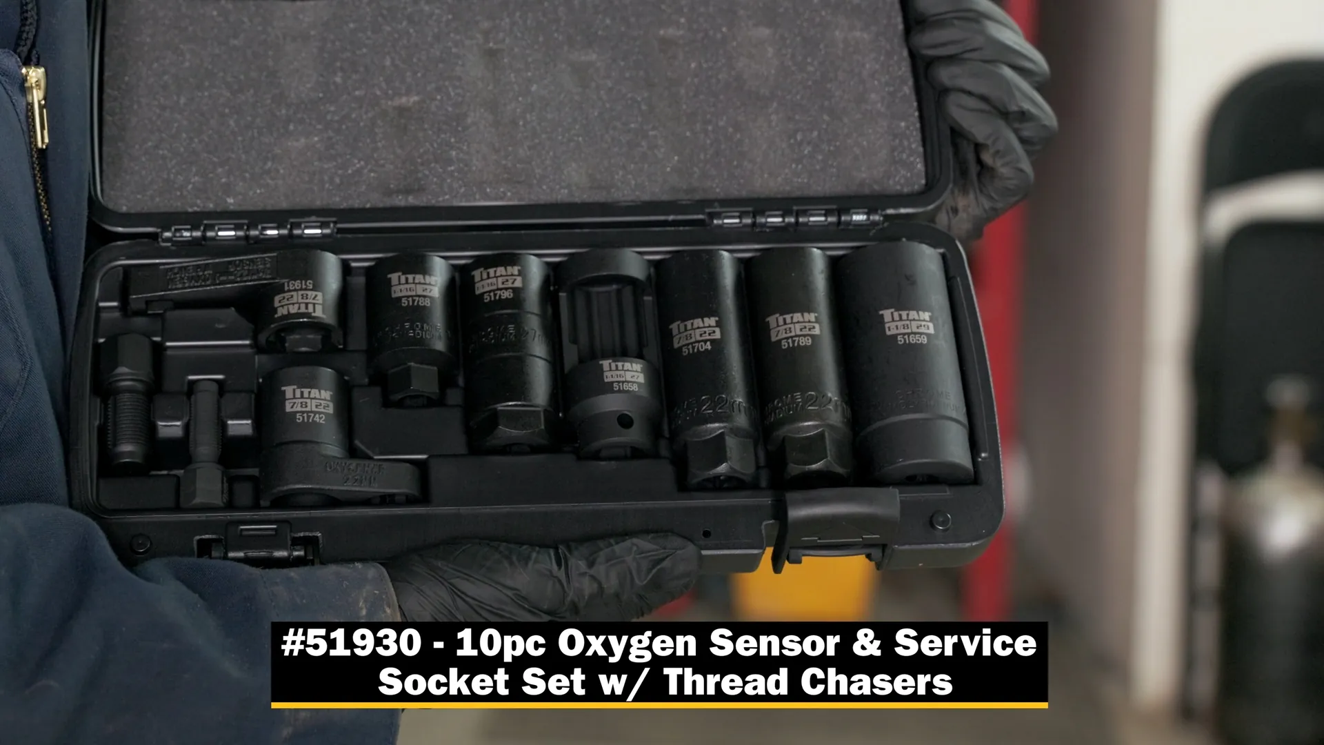 Gloved hands holding the open case of the Titan 51930 oxygen sensor and service socket set